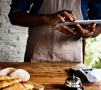 Man using digital tablet in baker's shop