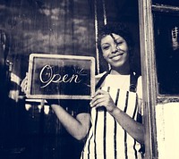 Woman Holding Open Sign by the Glass Window