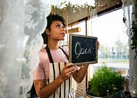 Woman Hanging Open Sign by the Glass Window