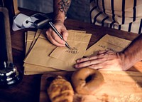 Hands Writing Thankful Words on Paper Bags