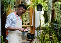Adult Man Checking Plants Outside Flowe Shop