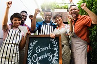 Group of diverse people with store grand opening board