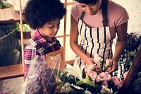 Mom Teaching Kid about Flowers in Flora Shop