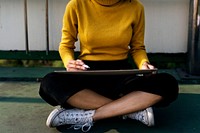 Girl sitting writing on a board