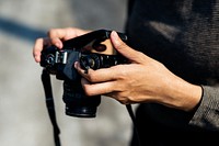 Closeup of hands checking film in camera