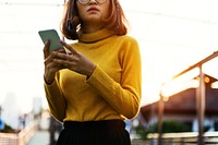 Girl with glasses using her mobile phone
