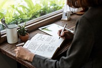 Closeup of girl writing on her journal