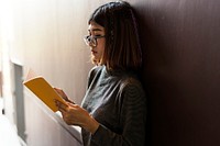 Girl with glasses reading a book