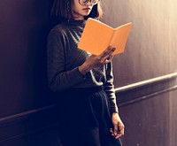 Girl with Glasses Standing Reading Book