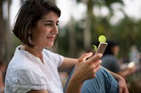 Adult Woman Sitting in The Park Using Mobile Phone