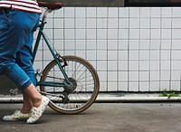 An Adult Woman Walking with Bicycle 