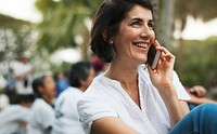 An Adult Woman Talking on The Phone in the Park