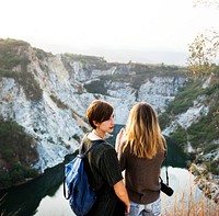 Girlfriends standing in rear view on top of the mountain