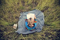 Woman reading book in field nature relax