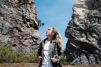 Woman standing in the middle of two rock structure looking lost