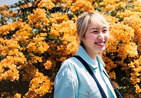 Asian woman with orange flowers in the background