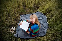 Woman reading book in field nature relax
