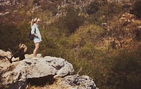 Woman standing on top of a mountain