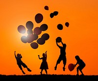 Children Outdoors Playing Balloons in Sunset