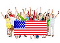 Cheerful Multi-Ethnic Group Of People Standing With Their Arms Raised Holding American Flag.