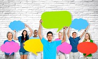 Multi-ethnic group of people holding colorful speech bubbles.