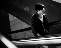 Handsome asian guy on the escalator