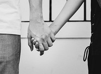 Closeup of couple holding hands 