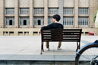 Guy sitting on a bench alone