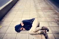 Young Asian Male Lying on the Street Depression