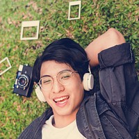 Young asian man lying relax listening music