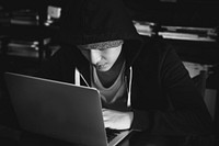Young guy in a hoodie using laptop
