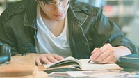 Student writing on a notebook