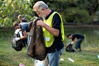 Diverse Group of People Pick Up Trash in The Park Volunteer Community Service