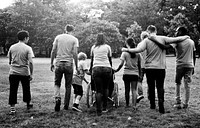 Group of friends supprt and walking together in rear view