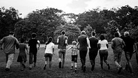 Group of people walking and running playful in the park