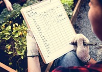 Woman checking list on clipboard for organic fresh agricultural