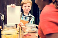 Boy selling lemonade juice at healthy product fair