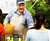 Grocery owner selling healthy product to customer