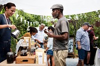 Man Selling Coffee Fresh Brew to People at Market