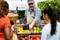 Greengrocer selling organic fresh agricultural product at farmer market