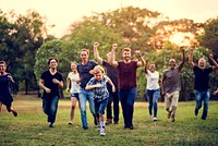 Group of people walking and running playful in the park