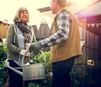 Senior Couple Planting Watering Garden Lifestyle