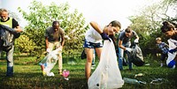 Diverse Group of People Picking Up Trash in The Park Volunteer Community Service