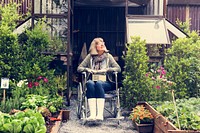Senior adult woman on wheelchair in the garden