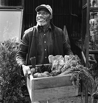 Man holding crate of organic fresh agricultural product