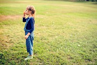 Little Girl Blowing Bubble at Grass Field Park Outdoor