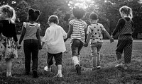 Black and white image of children walking at the park