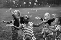 Children playing bubbles in a park