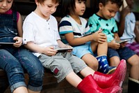 Group of Diverse Kids Using Mobile Phone Device Together