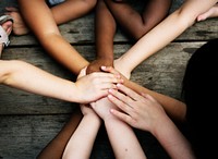 Group of diverse children holding hands together